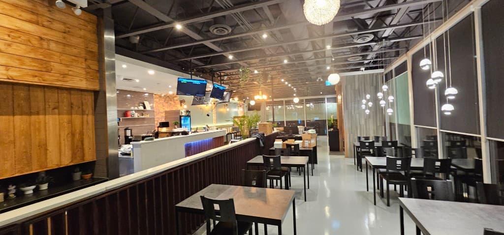 SizzlePan spacious dining room with modern tables and wood accents