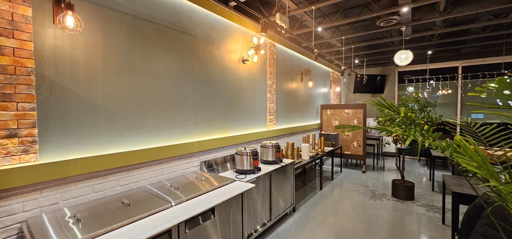 SizzlePan dining area with polished floors and pendant lighting